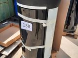 a black and white trash can sitting on a pallet