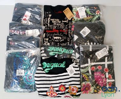 a lot of t - shirts that are on a table