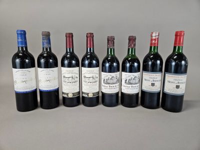 several bottles of wine are lined up on a table