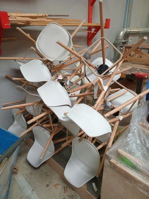 a pile of chairs that are stacked on top of each other