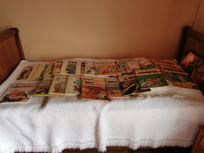 a bed that has a bunch of newspapers on it