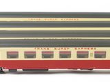 two toy trains sitting side by side on a white surface