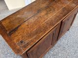 an old wooden chest on the floor in a garage