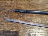 a pen that is sitting on a table next to a pencil