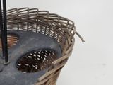 a wicker basket with an umbrella on top of it