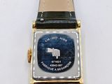 a watch that is sitting on a white surface