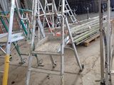 many ladders that are sitting in a warehouse