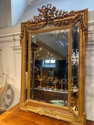 a mirror sitting on top of a wooden table