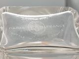 a glass container with a silver lid sitting on a table