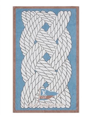 a blue and white rug with a boat and rope on it