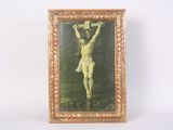 an old picture of jesus on the cross hanging on a wall