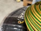 a yellow and green hose sitting on top of a plastic bag