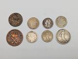 six different british coins sitting on top of a white surface