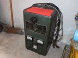 a green machine that is sitting in the corner of a room