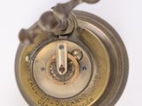 a close up of a clock on a white surface
