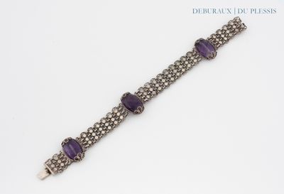 a close up of a bracelet with purple stones on it