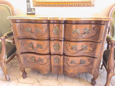 a wooden dresser with ornate carvings on it