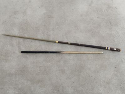 an old snooker cue and a cue stick laying on a table