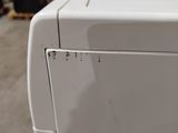an image of a white washer and dryer in a warehouse