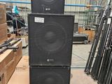 two speakers stacked on top of each other in a warehouse