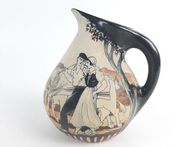 a black and white vase with a picture of a man and woman on it