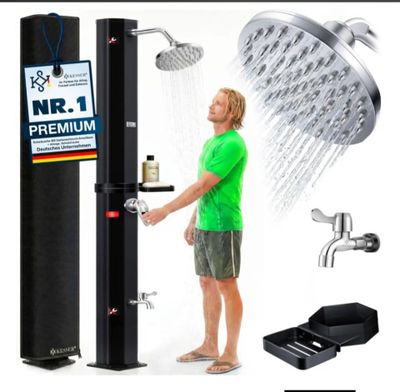 the man is standing in front of a shower with a green shirt