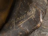 a close up of a bronze statue of a baseball player