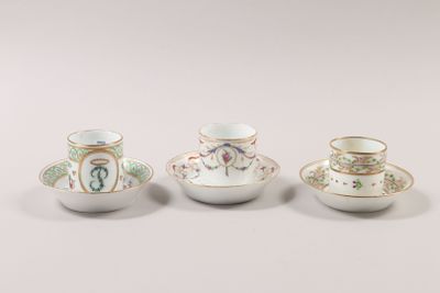 three small cups and saucers sitting next to each other on a table
