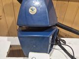 a blue machine that is sitting on a table