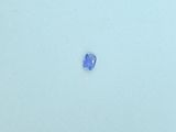 an oval shaped blue sapphire stone on a white surface