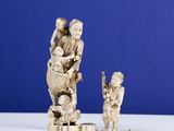 two figurines of a man and a child on a table