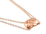 a close up of a rose gold diamond pendant on a chain