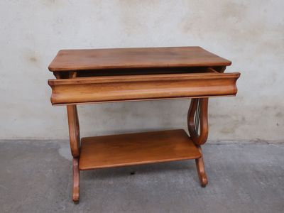 an old wooden table with a drawer on top of it