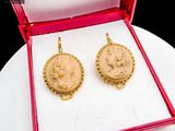a pair of earrings in a box on a table