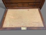 a wooden chest with drawers and drawers on top of it