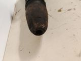 a pipe that is sitting on the floor next to a wall