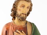 a statue of a man with a beard and a green shirt