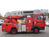 a red fire truck that is parked in a parking lot