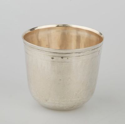 a silver cup on a white surface with a white background