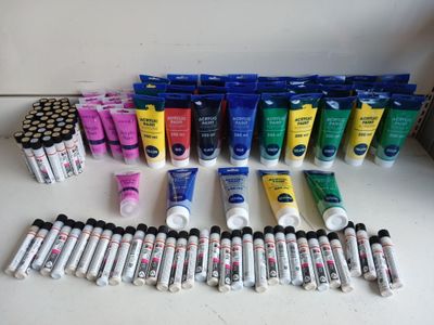 de nombreux tubes de peinture et de colle sur la table