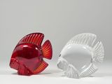 pair of red and clear glass fish figurines on a white surface