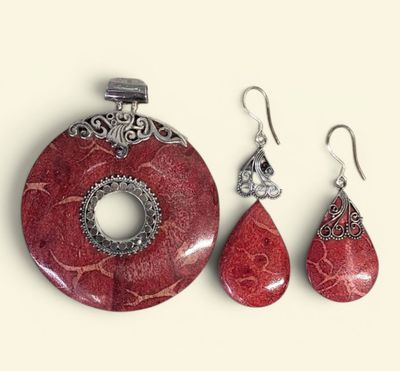 a picture of a jewelry set with a red stone