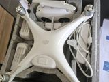 a white drone sitting inside of a case on the floor