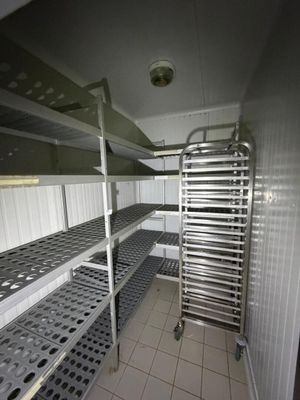 a metal rack in the middle of a room with shelves