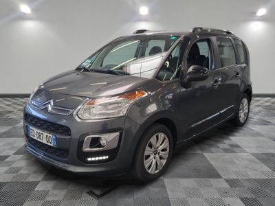 the grey citrole is parked on a checkered tile floor