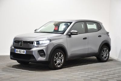 a silver suv parked in a room with a checkered floor