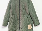 the jacket is green and black with a hood on it