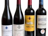 several bottles of wine are lined up on a white surface