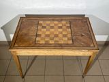 a small wooden table with a chess board on it