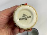 a person holding a small cup with a coin in it